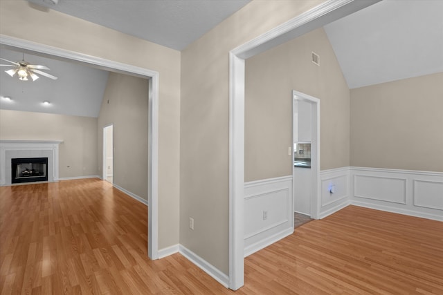 interior space featuring vaulted ceiling, visible vents, and light wood-type flooring