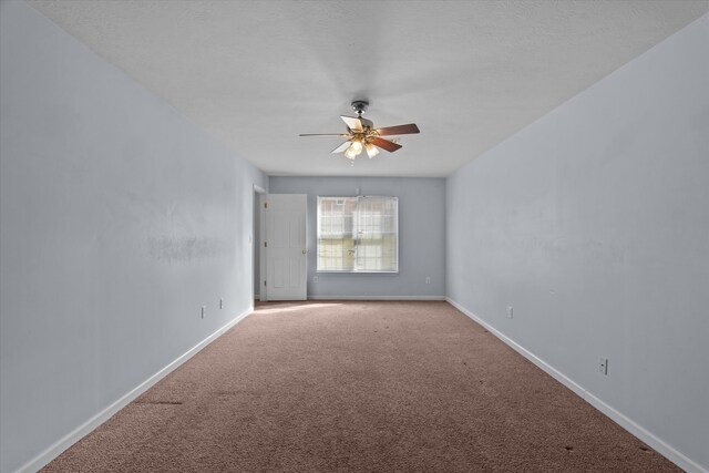 unfurnished room featuring a ceiling fan, baseboards, carpet floors, and a textured ceiling