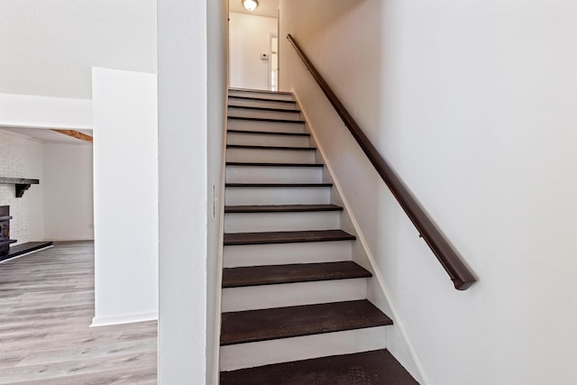 stairs with baseboards and wood finished floors