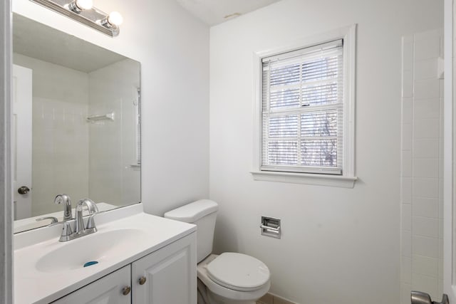 bathroom with a shower, vanity, and toilet