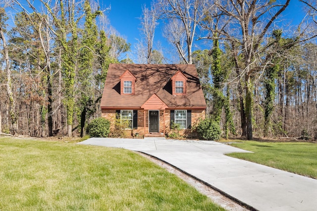 view of front of house with a front lawn and brick siding