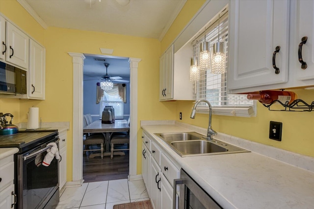 kitchen featuring ceiling fan, sink, black appliances, pendant lighting, and white cabinetry