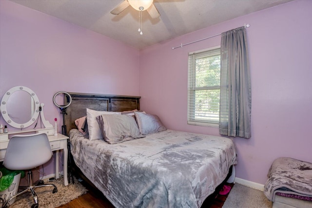 bedroom with ceiling fan and a textured ceiling