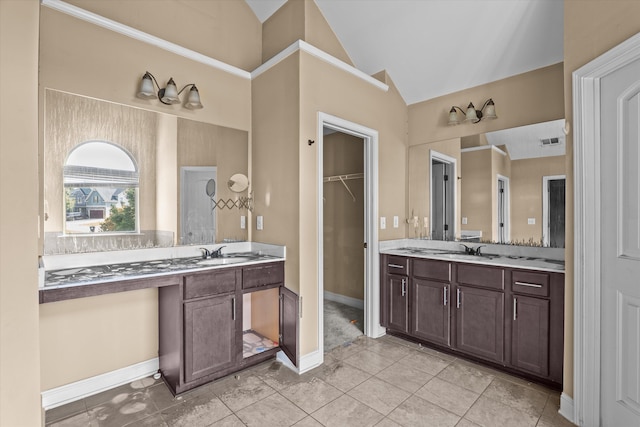 220 Dripping Rock Pass, Grovetown, GA 30813 - bathroom with vaulted ceiling, two vanities, and tile patterned flooring