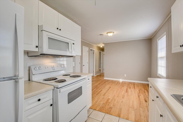 kitchen featuring tasteful backsplash, white cabinets, white appliances, and light hardwood / wood-style flooring