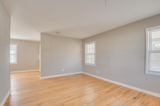 spare room with light hardwood / wood-style flooring