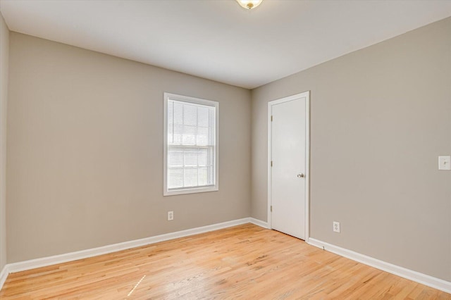 empty room with light hardwood / wood-style flooring