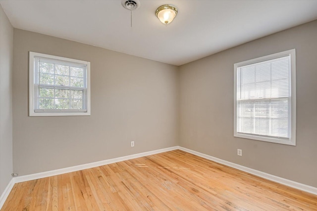 unfurnished room featuring hardwood / wood-style flooring