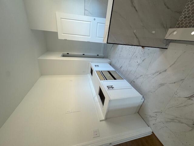 kitchen with hardwood / wood-style floors and white cabinets