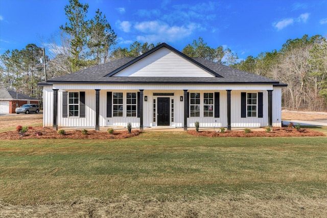 view of front of home with a front lawn, a porch, and board and batten siding