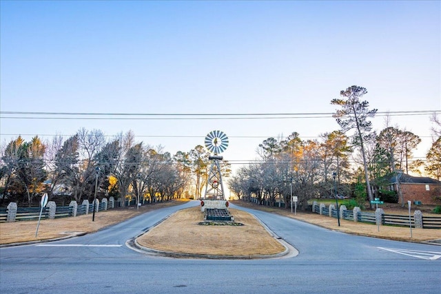 view of road featuring curbs and traffic signs