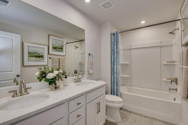 bathroom with toilet, a sink, and visible vents