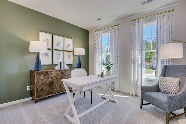 carpeted office with visible vents and baseboards