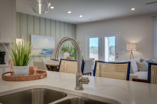 room details with recessed lighting, a sink, and light stone countertops