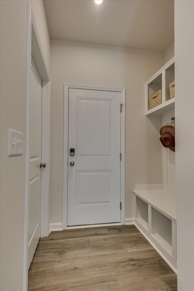 mudroom featuring wood finished floors and baseboards