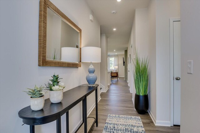 corridor with recessed lighting, baseboards, and wood finished floors