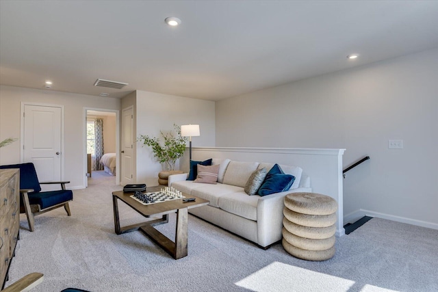 carpeted living area with baseboards, visible vents, and recessed lighting