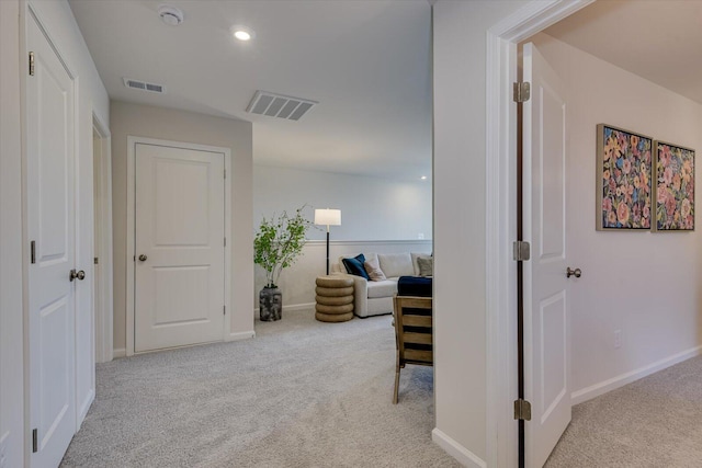 hallway featuring carpet floors, recessed lighting, visible vents, and baseboards