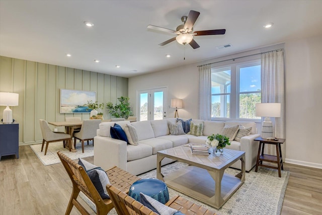 living area with a healthy amount of sunlight, light wood-style flooring, visible vents, and recessed lighting