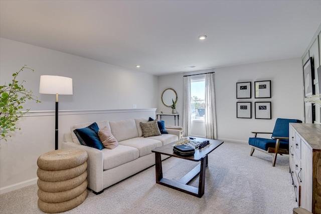 living room with recessed lighting, baseboards, and light colored carpet