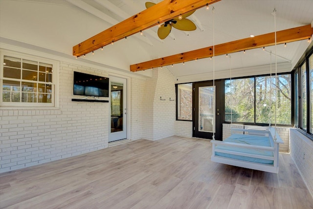 unfurnished sunroom with lofted ceiling with beams, a ceiling fan, and track lighting