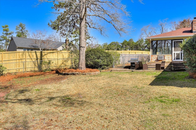 view of yard featuring fence and a sunroom