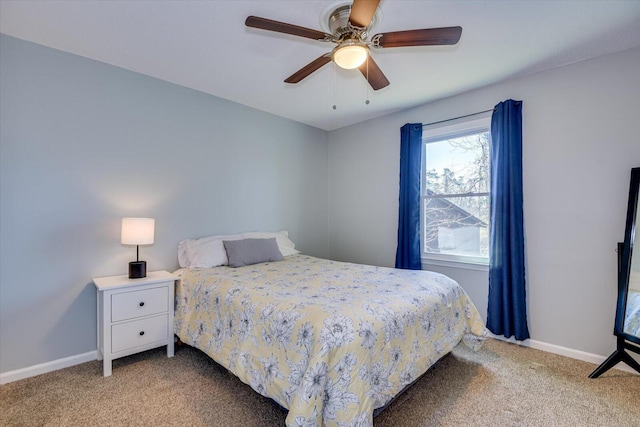 carpeted bedroom featuring baseboards and a ceiling fan