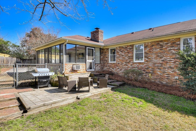 rear view of house with fence, a yard, a chimney, a patio area, and brick siding