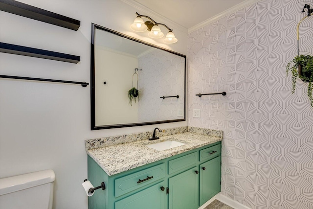 bathroom featuring vanity, crown molding, and toilet