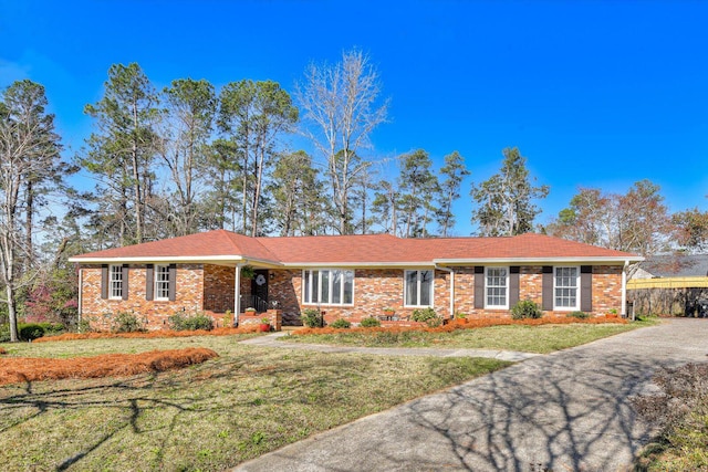 ranch-style home with brick siding and a front lawn