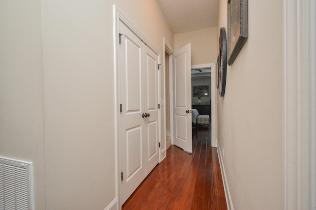 corridor with dark hardwood / wood-style floors