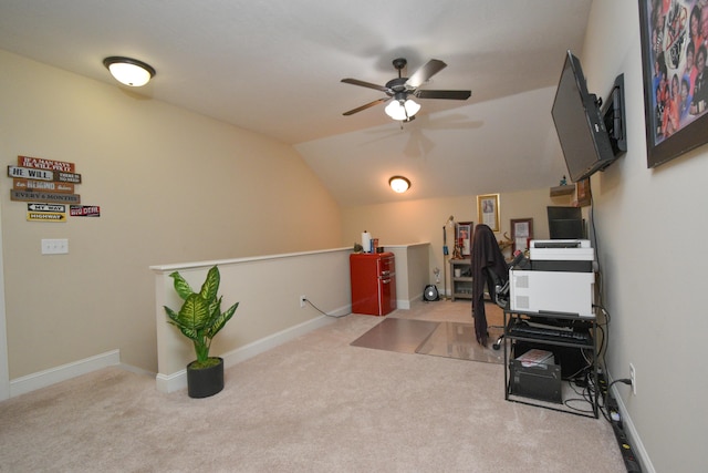 office area featuring ceiling fan, light colored carpet, and vaulted ceiling