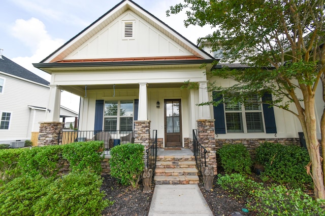 view of front of property with cooling unit and a porch