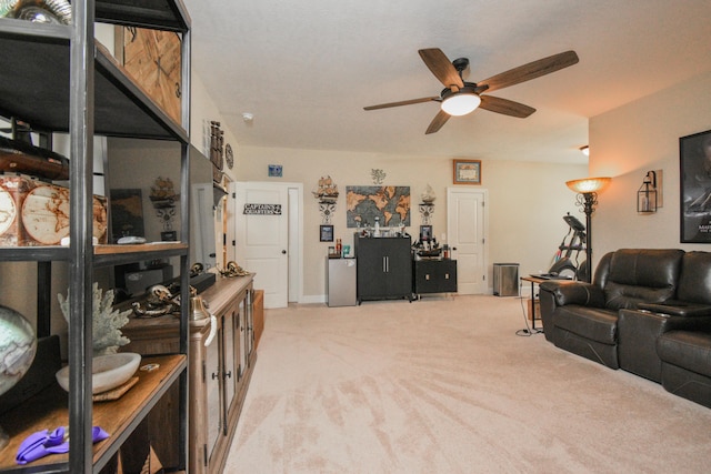 carpeted living room with ceiling fan