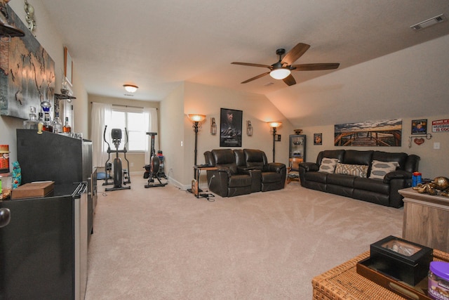 living room featuring light colored carpet, vaulted ceiling, and ceiling fan