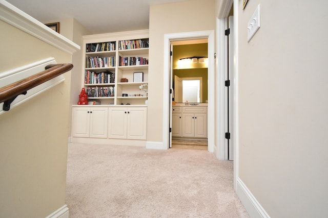 corridor featuring light colored carpet