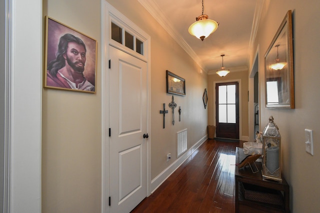 doorway to outside with dark hardwood / wood-style flooring and crown molding