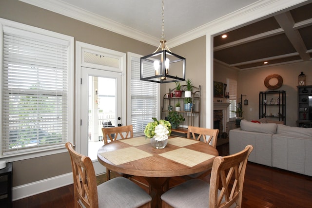 dining space with ornamental molding, dark wood-type flooring, and an inviting chandelier