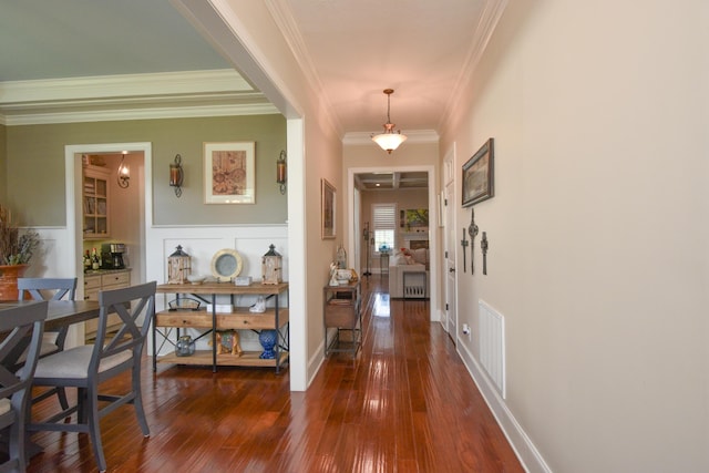 foyer featuring crown molding and dark hardwood / wood-style floors