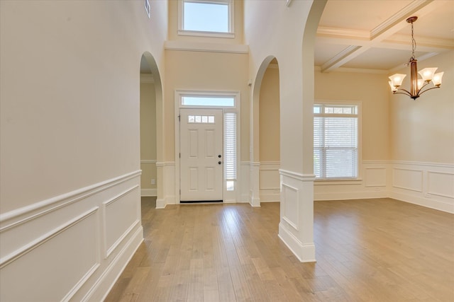 1037 Dietrich Ln, North Augusta, SC 29860 - foyer with plenty of natural light, arched walkways, beam ceiling, a decorative wall, and wainscoting