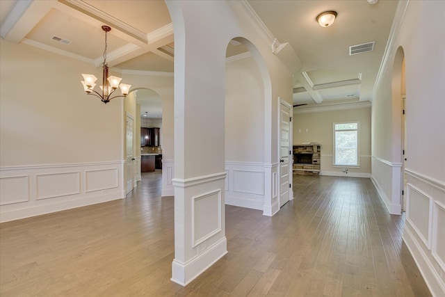 1037 Dietrich Ln, North Augusta, SC 29860 - hall with coffered ceiling, a decorative wall, beamed ceiling, arched walkways, and wood finished floors