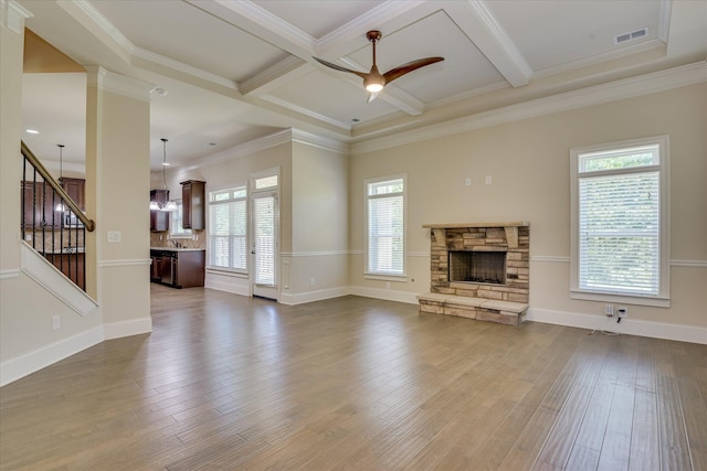 1037 Dietrich Ln, North Augusta, SC 29860 - unfurnished living room with ceiling fan, a fireplace, beamed ceiling, wood finished floors, and stairs