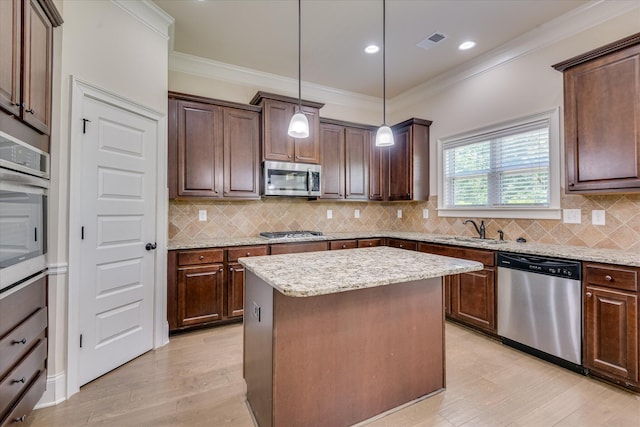 1037 Dietrich Ln, North Augusta, SC 29860 - kitchen with appliances with stainless steel finishes, light wood-style floors, a kitchen island, light stone countertops, and crown molding