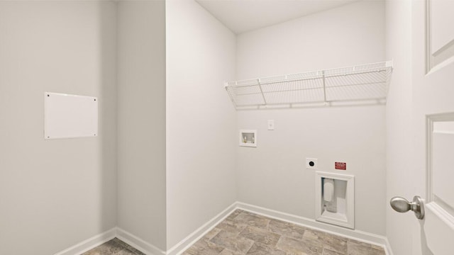 clothes washing area with hookup for a washing machine, baseboards, laundry area, electric dryer hookup, and stone finish flooring