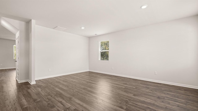 empty room featuring dark wood finished floors, recessed lighting, and baseboards