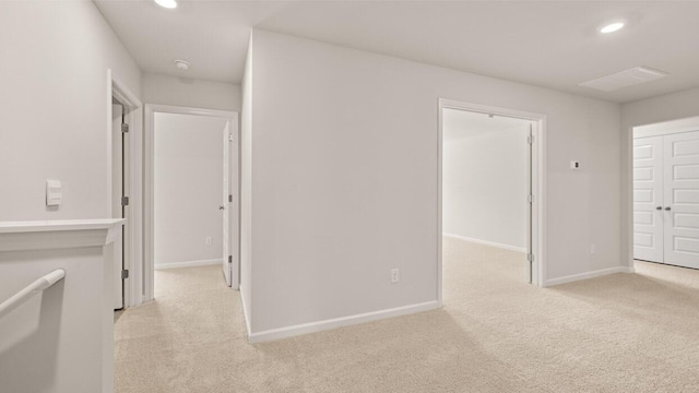 interior space featuring recessed lighting, light colored carpet, and baseboards