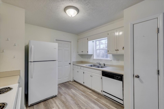 kitchen with light wood-style flooring, white appliances, a sink, white cabinets, and light countertops