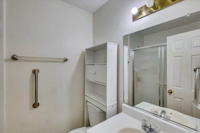 full bathroom featuring a sink and a shower stall