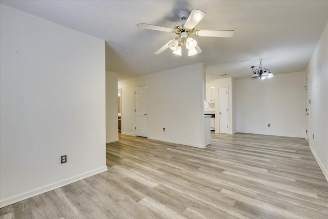 unfurnished living room featuring light wood-style flooring, baseboards, and ceiling fan with notable chandelier