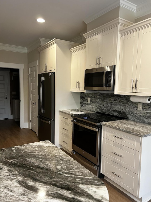 217 Holly Ln, Mccormick, SC 29835 - kitchen with appliances with stainless steel finishes, ornamental molding, dark wood-style flooring, backsplash, and recessed lighting